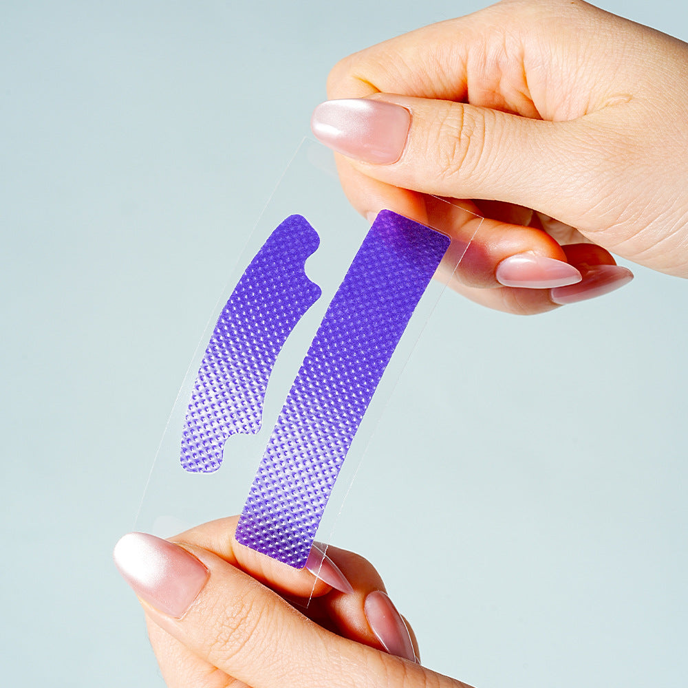 A pair of violet V34 whitening strips held between two hands